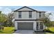 Charming two-story home with a two-car garage and well-maintained landscaping at 11944 Miracle Mile Dr, Riverview, FL 33578