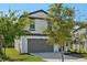 Beautiful home exterior featuring a well-manicured lawn and a spacious driveway at 11944 Miracle Mile Dr, Riverview, FL 33578