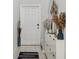 Bright foyer with decorative accents and a sleek storage unit at 11944 Miracle Mile Dr, Riverview, FL 33578