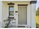 Inviting front door with a small table and chairs creating a cozy entrance at 11944 Miracle Mile Dr, Riverview, FL 33578