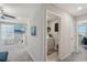 Hallway featuring view into laundry room and large media room with flat screen television at 11944 Miracle Mile Dr, Riverview, FL 33578