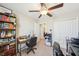 Well-lit home office featuring a ceiling fan, bookshelves, a cozy desk, and ample storage with closet at 11944 Miracle Mile Dr, Riverview, FL 33578