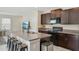 Well-equipped kitchen with an island, dark cabinets, and modern appliances at 11944 Miracle Mile Dr, Riverview, FL 33578