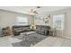 Inviting living room with a sectional sofa, decorative art, and large windows for natural light at 11944 Miracle Mile Dr, Riverview, FL 33578