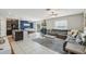 Open-concept living room with tile floors, modern decor, and a comfortable seating area at 11944 Miracle Mile Dr, Riverview, FL 33578