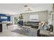 Bright living room with a plush gray sectional sofa and a stylish zebra-print rug at 11944 Miracle Mile Dr, Riverview, FL 33578