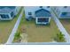 Aerial view of spacious backyard with vinyl fence, tropical trees and screened in porch at 12294 Cypress Branch St, Riverview, FL 33579
