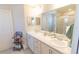Bathroom with dual sinks, white cabinets, and a large mirror, offering ample counter space at 12294 Cypress Branch St, Riverview, FL 33579
