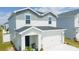 Attractive two-story home with a two-car garage, manicured lawn, and neutral color scheme at 12294 Cypress Branch St, Riverview, FL 33579