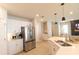 Modern kitchen area with stainless steel appliances, white cabinets, an island with sink and pendant lighting at 12294 Cypress Branch St, Riverview, FL 33579
