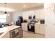 Well-equipped kitchen featuring stainless steel appliances, white cabinetry, and a kitchen island that provides counter seating at 12294 Cypress Branch St, Riverview, FL 33579