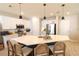 Modern kitchen island with a white countertop, dark base, pendant lighting, stainless steel appliances, and barstool seating at 12294 Cypress Branch St, Riverview, FL 33579