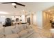 Open concept living room features a ceiling fan and views of the modern kitchen with an island and barstool seating at 12294 Cypress Branch St, Riverview, FL 33579