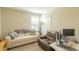 Cozy living room features a comfortable sofa, a recliner chair, and a workspace area at 12294 Cypress Branch St, Riverview, FL 33579
