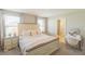 Sunlit bedroom features a king bed, two nightstands, two windows, and a vanity desk at 12294 Cypress Branch St, Riverview, FL 33579