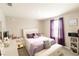 Inviting main bedroom with large window, ample natural light, light-colored carpet, and elegant lavender accents at 12294 Cypress Branch St, Riverview, FL 33579