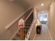 Hall with staircase featuring wood railing and decor, with open view to the living room at 12294 Cypress Branch St, Riverview, FL 33579
