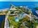 Aerial view of a waterfront park with pier, playground, sandy beach, and boat docks at 130 4Th N Ave # 315, St Petersburg, FL 33701