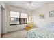 Bright bedroom features floral bedding, vintage chair, and large window with AC unit at 130 4Th N Ave # 315, St Petersburg, FL 33701