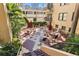 Charming courtyard featuring colorful tiled floors, tables with umbrellas, and well-maintained landscaping at 130 4Th N Ave # 315, St Petersburg, FL 33701