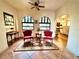 Cozy living room featuring two red accent chairs and plenty of natural light at 130 4Th N Ave # 315, St Petersburg, FL 33701