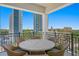 A view from a balcony showcasing outdoor seating and a scenic cityscape featuring high-rise buildings at 146 4Th Ne Ave # 600, St Petersburg, FL 33701