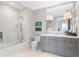 Modern bathroom featuring a glass-enclosed shower, subway tile, and a gray vanity with ample storage at 146 4Th Ne Ave # 600, St Petersburg, FL 33701