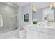 Bright bathroom with a glass shower, white subway tiles, and a large vanity with modern fixtures at 146 4Th Ne Ave # 600, St Petersburg, FL 33701