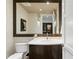 Stylish powder room with unique wallpaper, modern lighting, framed mirror, and a dark wood vanity at 146 4Th Ne Ave # 600, St Petersburg, FL 33701