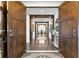 Grand foyer with a long hallway, wood floors, modern console table and stylish doors at 146 4Th Ne Ave # 600, St Petersburg, FL 33701