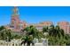 Beautiful exterior of a pink hotel with a tower and terra cotta roof surrounded by palm trees and lush greenery at 146 4Th Ne Ave # 600, St Petersburg, FL 33701