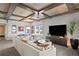 Spacious living room featuring coffered ceilings, a large sectional sofa, and modern entertainment center at 146 4Th Ne Ave # 600, St Petersburg, FL 33701