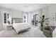 Spacious main bedroom with large windows and balcony access, adorned with neutral tones and stylish decor at 146 4Th Ne Ave # 600, St Petersburg, FL 33701