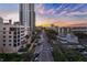 An aerial shot of a city street with tall buildings, a mix of historic and modern architecture, and a colorful sunset sky at 146 4Th Ne Ave # 600, St Petersburg, FL 33701