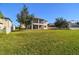 Expansive backyard with lush lawn and screened-in patio, perfect for outdoor entertaining at 19432 Whispering Brook Dr, Tampa, FL 33647