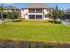 Aerial view of home and large backyard with screened-in lanai, and serene pond views at 19432 Whispering Brook Dr, Tampa, FL 33647