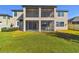 Home's screened lanai overlooks the lush lawn, perfect for relaxing and entertaining at 19432 Whispering Brook Dr, Tampa, FL 33647