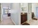 Hallway bathroom with wooden vanity, granite countertop and plenty of room at 19432 Whispering Brook Dr, Tampa, FL 33647