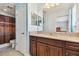 Bathroom featuring a vanity with a granite countertop and a toilet with a shower curtain at 19432 Whispering Brook Dr, Tampa, FL 33647