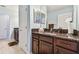 Bathroom with a vanity with granite countertops and a view of the doorway with two additional vanities at 19432 Whispering Brook Dr, Tampa, FL 33647