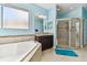 Bright bathroom featuring a soaking tub, granite countertop vanity, and walk-in shower at 19432 Whispering Brook Dr, Tampa, FL 33647