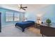 Well-lit bedroom with neutral carpet, complementary lamps, and a ceiling fan at 19432 Whispering Brook Dr, Tampa, FL 33647