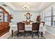 Dining room showcasing a chandelier, ornate mirror, dark wood cabinet, and elegant dining set with seating for six at 19432 Whispering Brook Dr, Tampa, FL 33647