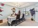 Dining room with a large window, light blue walls, chandelier, and a dining table set for entertaining at 19432 Whispering Brook Dr, Tampa, FL 33647