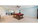 Large game room with a billiards table, neutral carpet, and ample space for entertainment at 19432 Whispering Brook Dr, Tampa, FL 33647