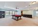 Spacious game room featuring a billiards table, a wet bar, and natural light at 19432 Whispering Brook Dr, Tampa, FL 33647