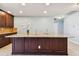 Kitchen island boasting granite countertops, rich dark wood cabinets, and ample counter space at 19432 Whispering Brook Dr, Tampa, FL 33647