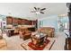 Open living room featuring kitchen, carpet, a ceiling fan, and lots of natural light, creating a spacious feel at 19432 Whispering Brook Dr, Tampa, FL 33647