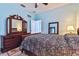 Spacious bedroom with a large mirror dresser and decorative paisley bedding at 19432 Whispering Brook Dr, Tampa, FL 33647