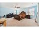 Bright main bedroom boasts ample space, a ceiling fan, and a full-sized desk with computer setup at 19432 Whispering Brook Dr, Tampa, FL 33647